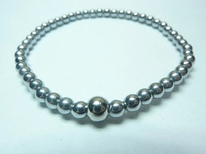 Bracelet en hématite naturelle qualité AAA en perles rondes montées sur fil élastique, bijou protecteur et équilibrant pour homme et femme.